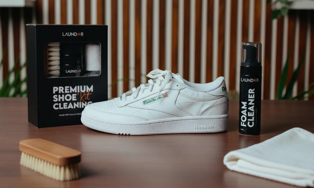 Clean white sneaker surrounded by LAUNDOR shoe-care kit and products