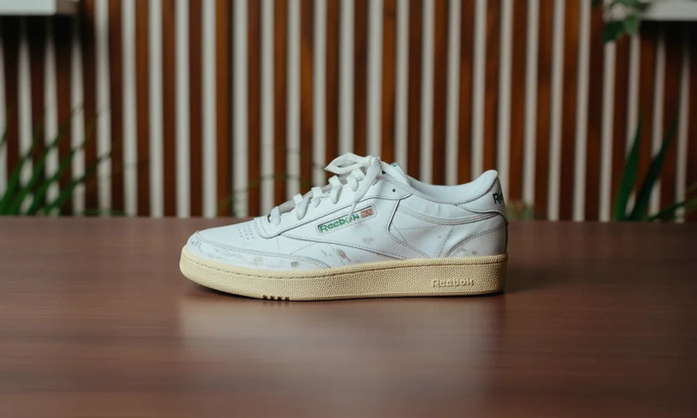 Dirty worn white sneaker before cleaning, same position as the after image